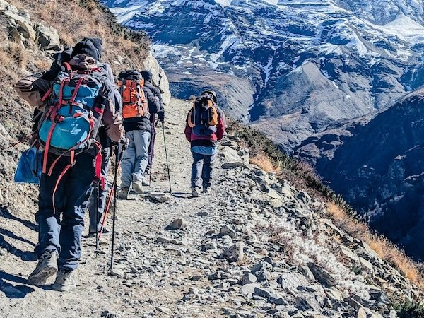 trekkers with stick - Staying Safe While Trekking in Nepal: Tips and Guidelines